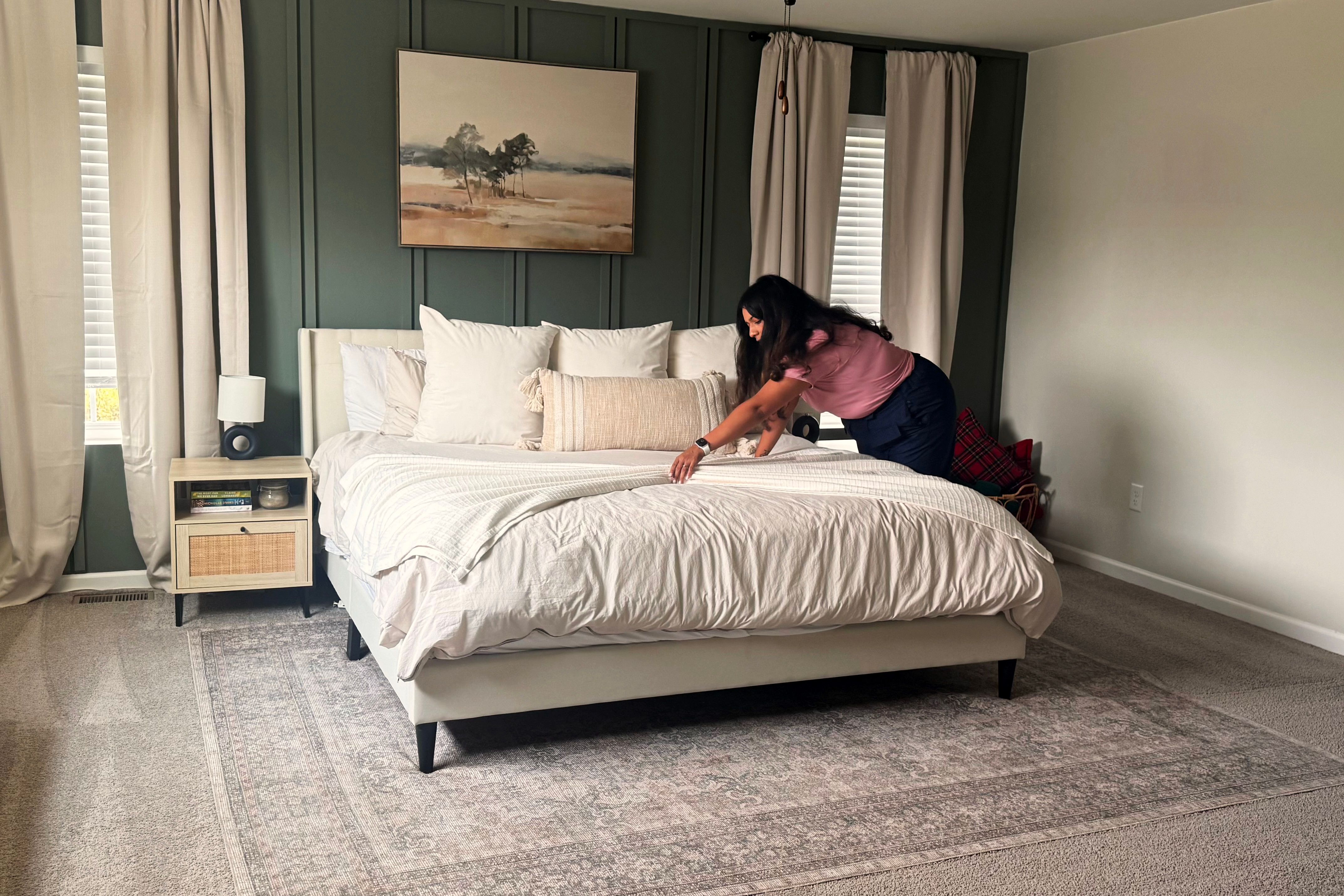 Veronica Navarro making a bed during a home cleaning