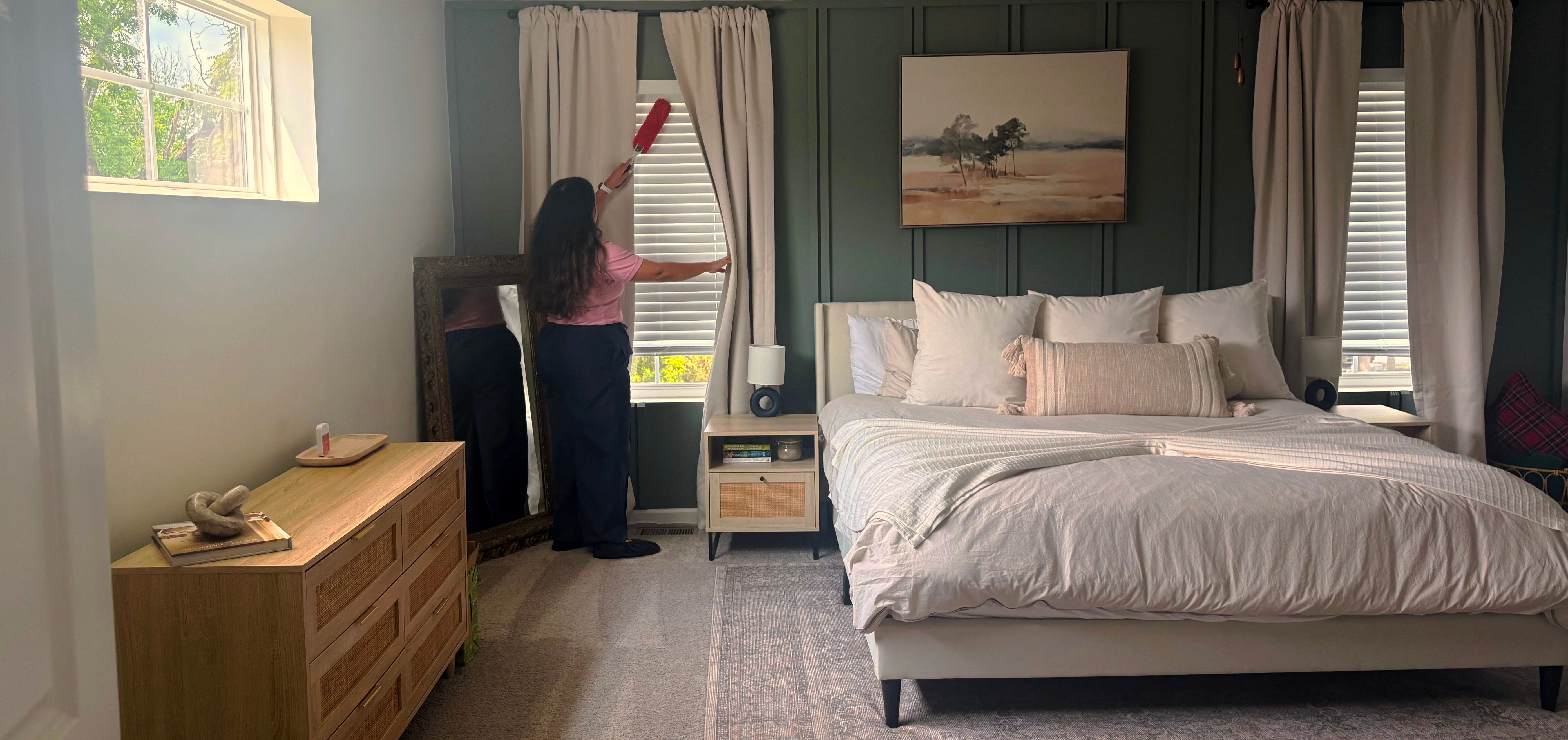 Capital Cleaning owner dusting window blinds in a bedroom